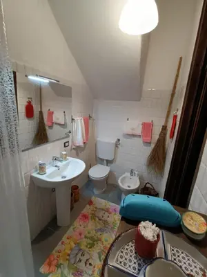 a small bathroom with a sink and a toilet at Syd's House in Bagheria