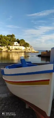 a boat sitting on the shore of a beach at Syd's House in Bagheria