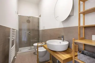 a bathroom with a sink and a shower and a toilet at Ninni's House by DomuSicily in Palermo