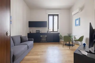 a living room with a couch and a table at Ninni's House by DomuSicily in Palermo