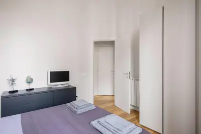 a bedroom with a bed and a tv on a dresser at Ninni's House by DomuSicily in Palermo