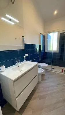 a bedroom with two beds and a window at Villa Corallo Sicily - Scopello Guidaloca Bay in Scopello