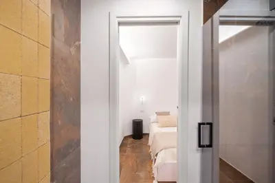 a white room with a bed and a window at A Casa di Giulia - elegante loft in centro storico in Palermo