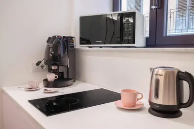 a coffee maker and a microwave on a kitchen counter at A Casa di Giulia - elegante loft in centro storico in Palermo