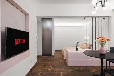 a living room with a television on a wall at A Casa di Giulia - elegante loft in centro storico in Palermo
