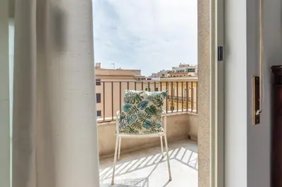 a chair sitting on a balcony with a view at Appartamento a due passi da Villa Trabia by Wonderful Italy in Palermo