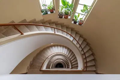 a spiral staircase with potted plants at Appartamento a due passi da Villa Trabia by Wonderful Italy in Palermo
