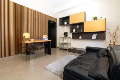 a living room with a couch and a table and a desk at Kanisa Mari e Monti in Cinisi