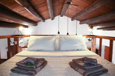 a bedroom with a bed with two towels on it at Cattedrale - VISTA HOUSE easy parking in Palermo