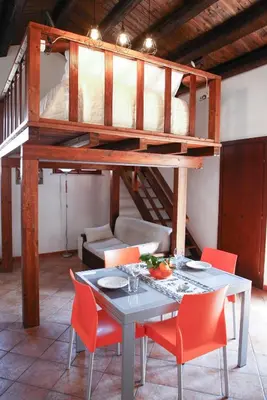 a room with a table with chairs and a bunk bed at Cattedrale - VISTA HOUSE easy parking in Palermo