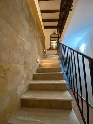 a set of stairs with a stone wall at La Casetta di Marianne in Santa Flavia