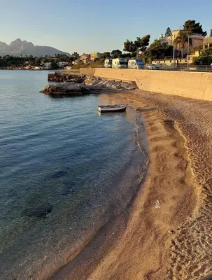 a boat sitting on the shore of a beach at La Casetta di Marianne in Santa Flavia