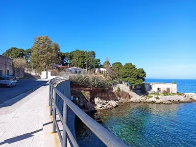 a bridge over a body of water next to a road at La Casetta di Marianne in Santa Flavia