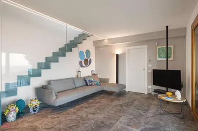 a living room with a couch and a staircase at Sea View Villa whit Pool in Scopello