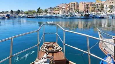 a boat is docked in a harbor with boats at Casa Lo Re in Santa Flavia