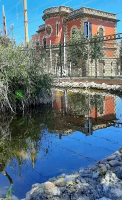 a reflection of a building in a body of water at Casa Lo Re in Santa Flavia