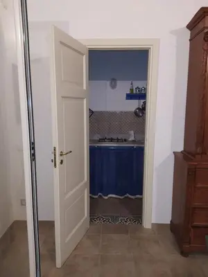 an open door to a kitchen with a sink at Casa Lo Re in Santa Flavia