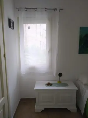 a white table in a room with a window at Casa Lo Re in Santa Flavia