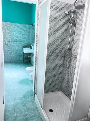 a bathroom with a shower and a toilet at Proserpina House in Palermo