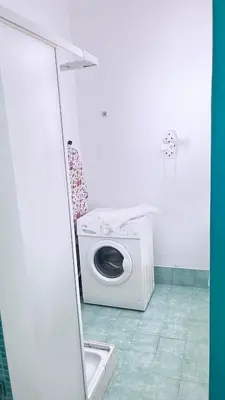 a washing machine in a bathroom with a mirror at Proserpina House in Palermo