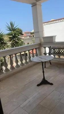 a bench sitting on top of a balcony at Proserpina House in Palermo