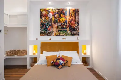 a bedroom with a large painting above a bed at Casa Brezi in Palermo
