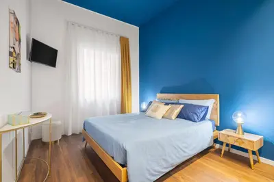 a blue bedroom with a bed and a blue wall at Casa Brezi in Palermo