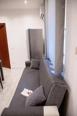 a living room with a couch and a window at Casa vacanze Rigano Palermo in Palermo