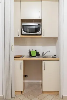 a kitchen with a sink and a microwave at Dimora Artale in Cattedrale in Palermo