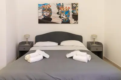 a bedroom with a bed with two towels on it at Dimora Artale in Cattedrale in Palermo