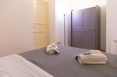 a bedroom with a bed with towels on it at Dimora Artale in Cattedrale in Palermo