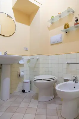 a bathroom with a toilet and a sink at Dimora Artale in Cattedrale in Palermo