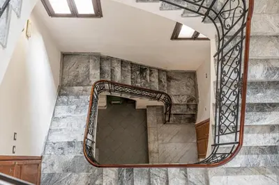 a spiral staircase in a building with a mirror at Stylish apartment near Piazza Magione by Wonderful Italy in Palermo