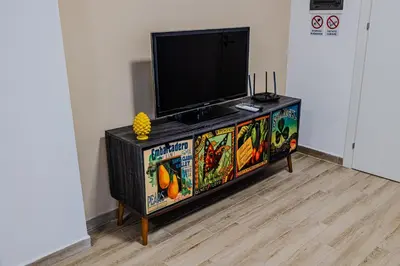 a flat screen tv sitting on top of a entertainment center at Villa delle Palme in Campofelice di Roccella