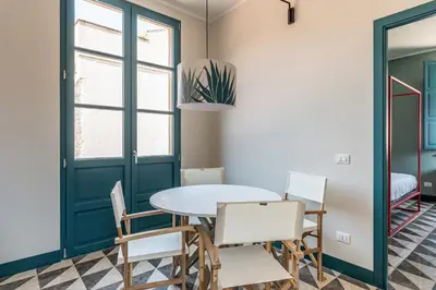 a dining room with a table and chairs at Casa San Francesco Rooms in Palermo