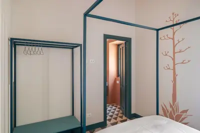a mirror in a room with a bed at Casa San Francesco Rooms in Palermo