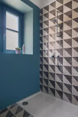 a bathroom with a shower with blue walls at Casa San Francesco Rooms in Palermo