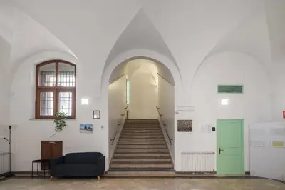a hallway with stairs and a green door at Casa San Francesco Rooms in Palermo