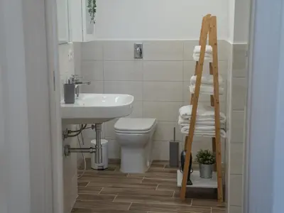 a bathroom with a sink and a toilet and a ladder at Central Station Home - Fanale Rentals in Palermo
