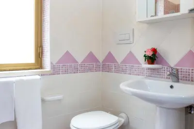 a bathroom with a toilet and a sink at Casa Longo 2 in Castellammare del Golfo