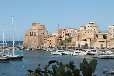 a group of boats in a harbor with buildings at Casa Longo 2 in Castellammare del Golfo