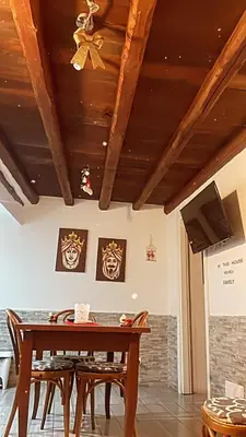 a dining room table with chairs and a ceiling at La casetta del borgo in Palermo