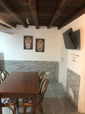 a dining room with a wooden table and chairs at La casetta del borgo in Palermo