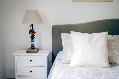 a bedroom with a bed with a nightstand and a lamp at Villa Marina Sant'Elia in Santa Flavia