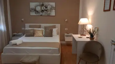 a bedroom with a bed and a table and a chair at Politeama Center in Palermo