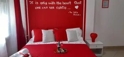 a bedroom with a red bed with a red headboard at Politeama Center in Palermo