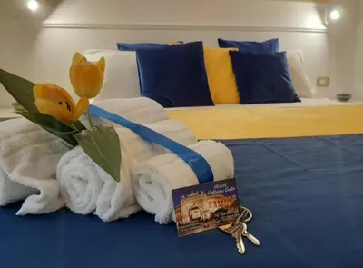 a hotel room with a bed with towels and flowers at Politeama Center in Palermo