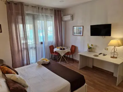 a hotel room with a bed and a table and a television at Politeama Center in Palermo