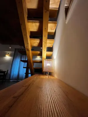 a chair in a room with a wooden ceiling at A casa del Conte in Palermo