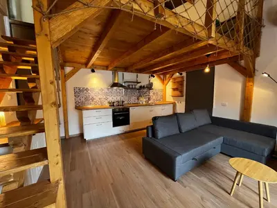 a living room with a couch and a kitchen at A casa del Conte in Palermo